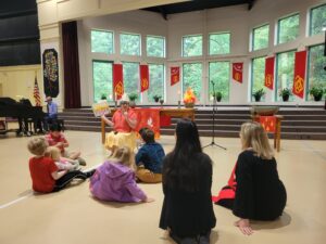 Women with children reading books during worship