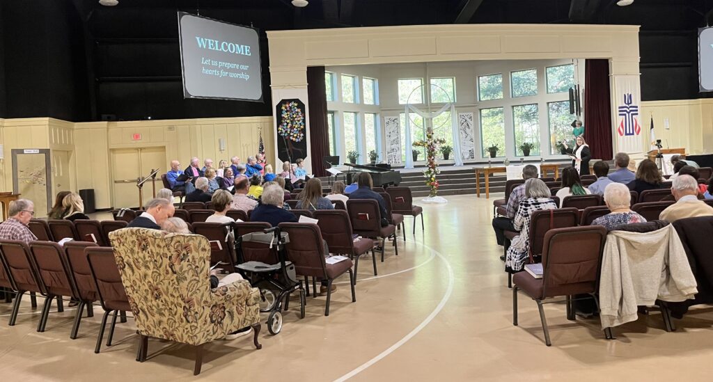 Multiple rows of people in the large Sanctuary. 